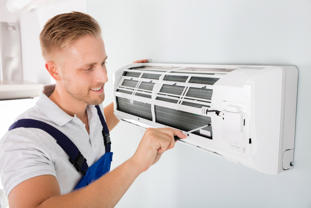 tech finishing up AC installation